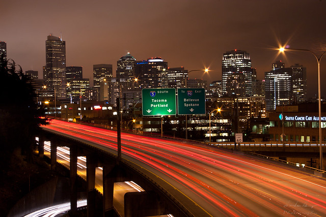 Tail lights of I-5 South with Seattle skyline