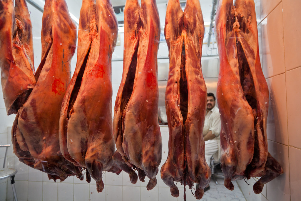 A row of meat | A butcher peeks through the hanging lamb car… | Flickr