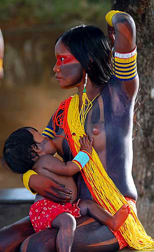 Flagrant the Indian mother breastfeeding her child, adorned with paintings, Photographer Unknown
