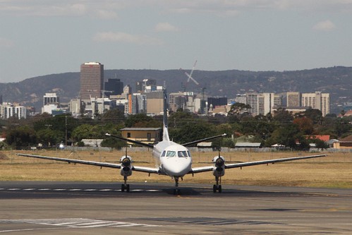 Regional Express Saab 340B with the Adelaide skyline behind