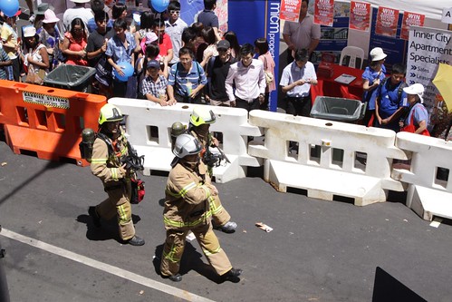 Firefighters in breathing gear investigate a fire alarm