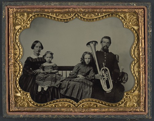 [Unidentified soldier in Union uniform with wife and daughters holding saxhorn] (LOC) | by The Library of Congress
