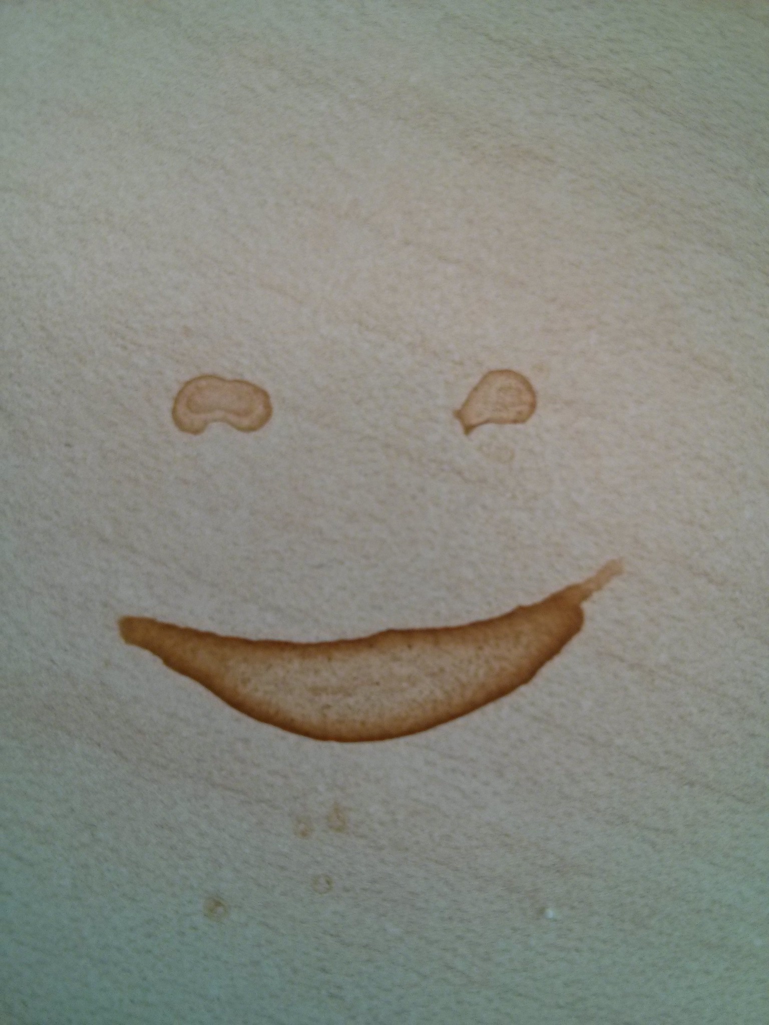 Smiley face in a coffee stain