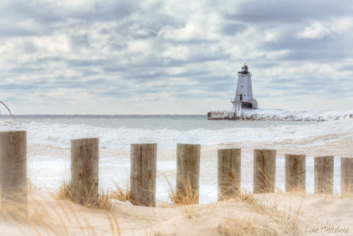 winter lighthouse lake snow seascape ice water grass clouds landscape outdoors pier afternoon ludingtonmichigan ludingtonlightstation