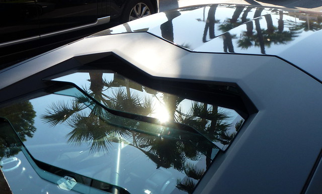 Black Lamborghini dreaming of Palm reflection on La Croisette