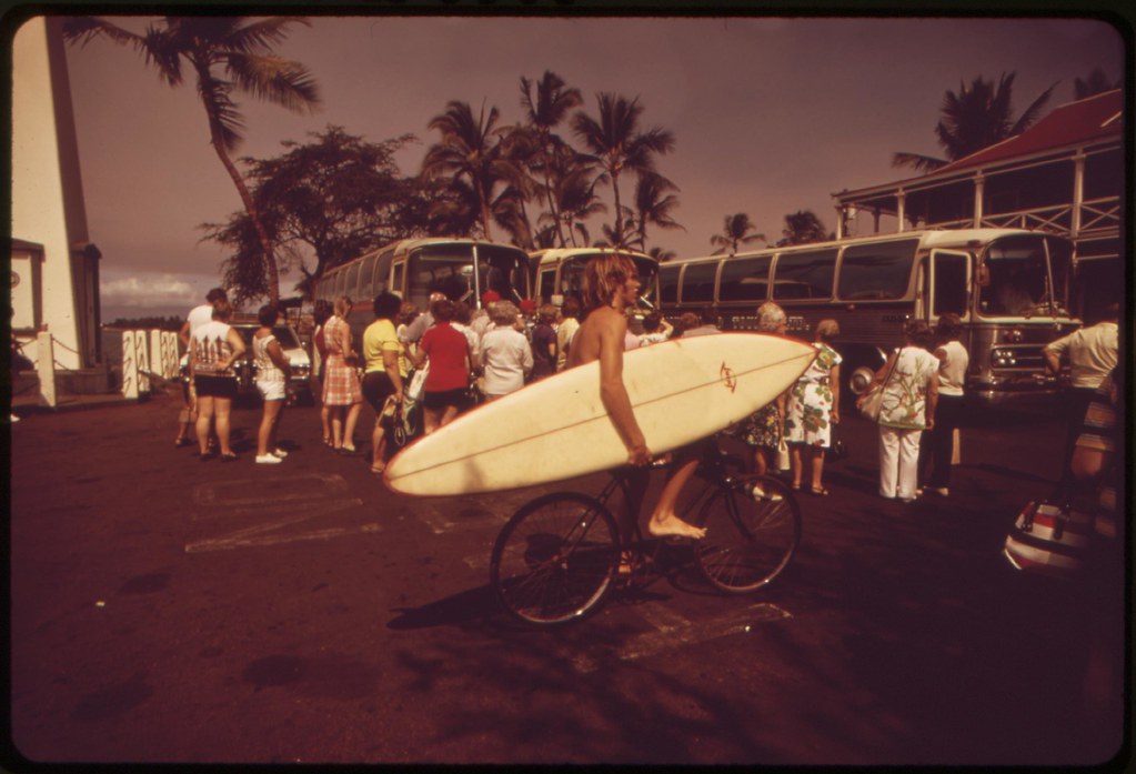 Tourists just off buses crowd premises outside waterfront hotel at Lahina. A few years ago this area was virtually empty, October 1973