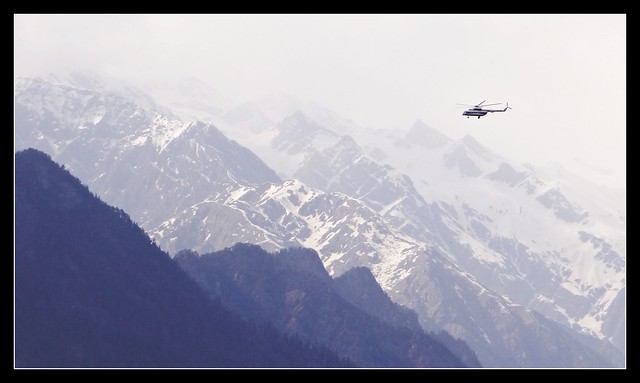 Sarahan - ITBP chopper flying past snow clad Himalayan peaks