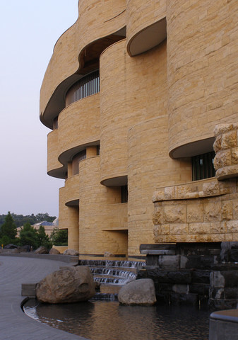 Facade of the National Museum of the American Indian, on the Mall, at dusk.