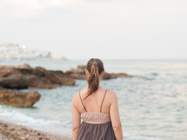Woman with pony tail looking at the Mediterrean Sea