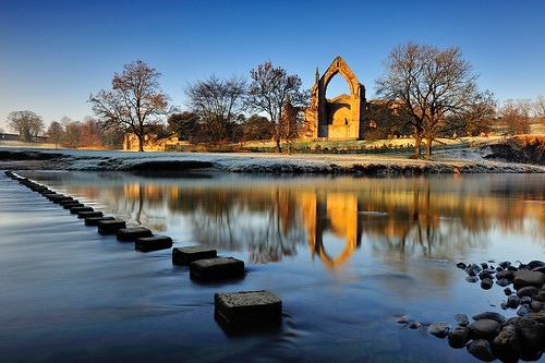 winter boltonabbey dawn dawnatboltonabbey ruins augustinian priory parish churchofsaintmaryandsaintcuthbert churchofstmaryandstcuthbert bolton abbey monastery sunlight golden hour yorkshiredalesnationalpark river wharfe dissolutionofthemonasteries 1154 devonshire estate northyorkshire stone imagestwiston morning national park yorkshire stepping stones blue sky cloudless frost frosty cold freezing reflections tree trees branch branches landscape dales reflected godsowncountry le longexposure 10stopnd rocks pebble rock pebbles tributary brook flowing stream wow