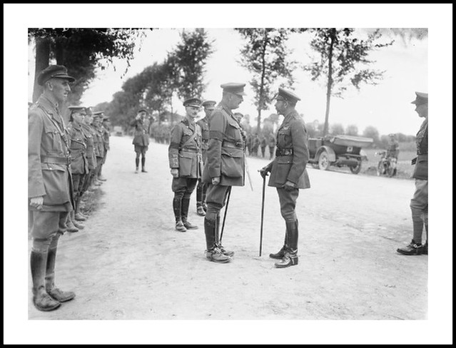 HM King George V & HRH The Prince of Wales . H.M. the King conversing with Major-General G.G. Blackader (38th Division); Wormhoudt, 13th August 1916. Troops of the Division are along the road.