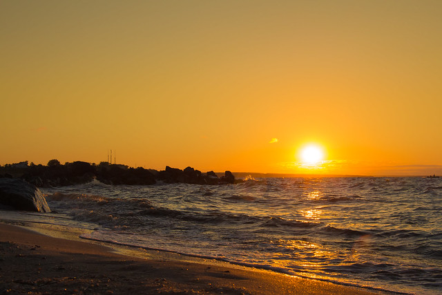 Big orange sun rising over horison on Azov sea