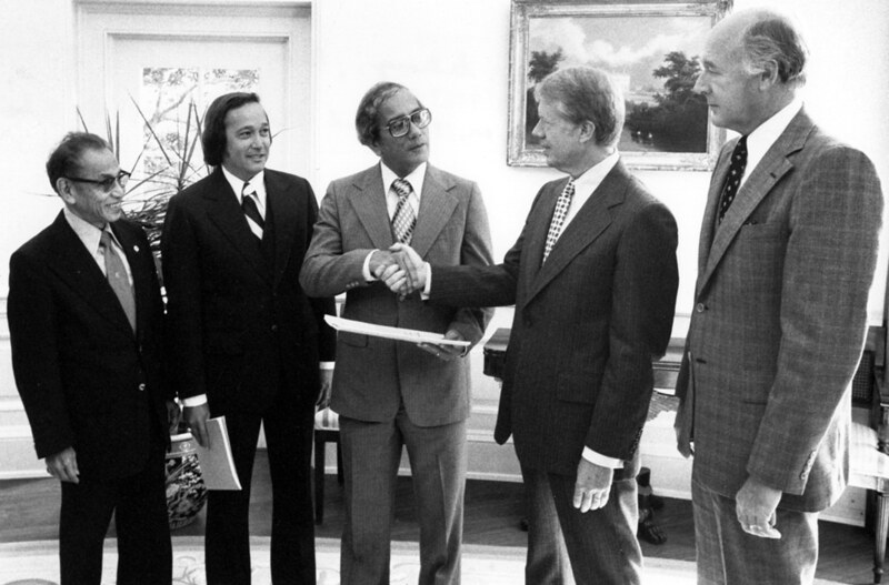 Governor Ricardo J. Bordallo shakes hands with President Jimmy Carter. From left to right: Congressman Antonio Won Pat, Senator Carl Gutierrez, Governor Ricardo "Ricky" Bordallo, President James "Jimmy  Carter and Secretary of Interior Cecil D. Andrus. Courtesy of the Micronesian Area Research Center (MARC).