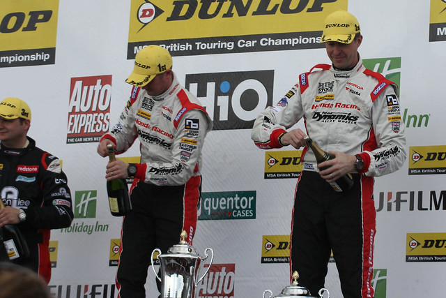 Gordon Sheddon, Matt Neal and Mat Jackson celebrate their top three places on the podium at the BTCC race at Donington Park in April 2012