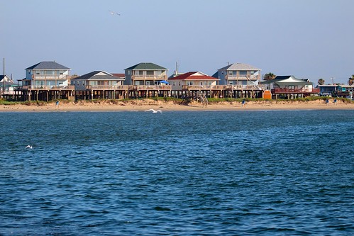houses lined along the coast of an ocean