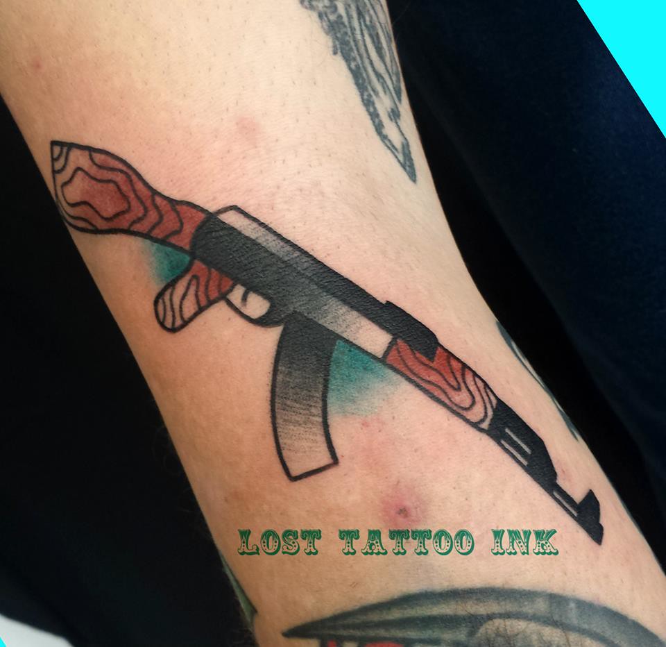 Ak47 tattoo on arm.