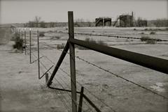 Barbed wire fence and oil tanks, West Texas