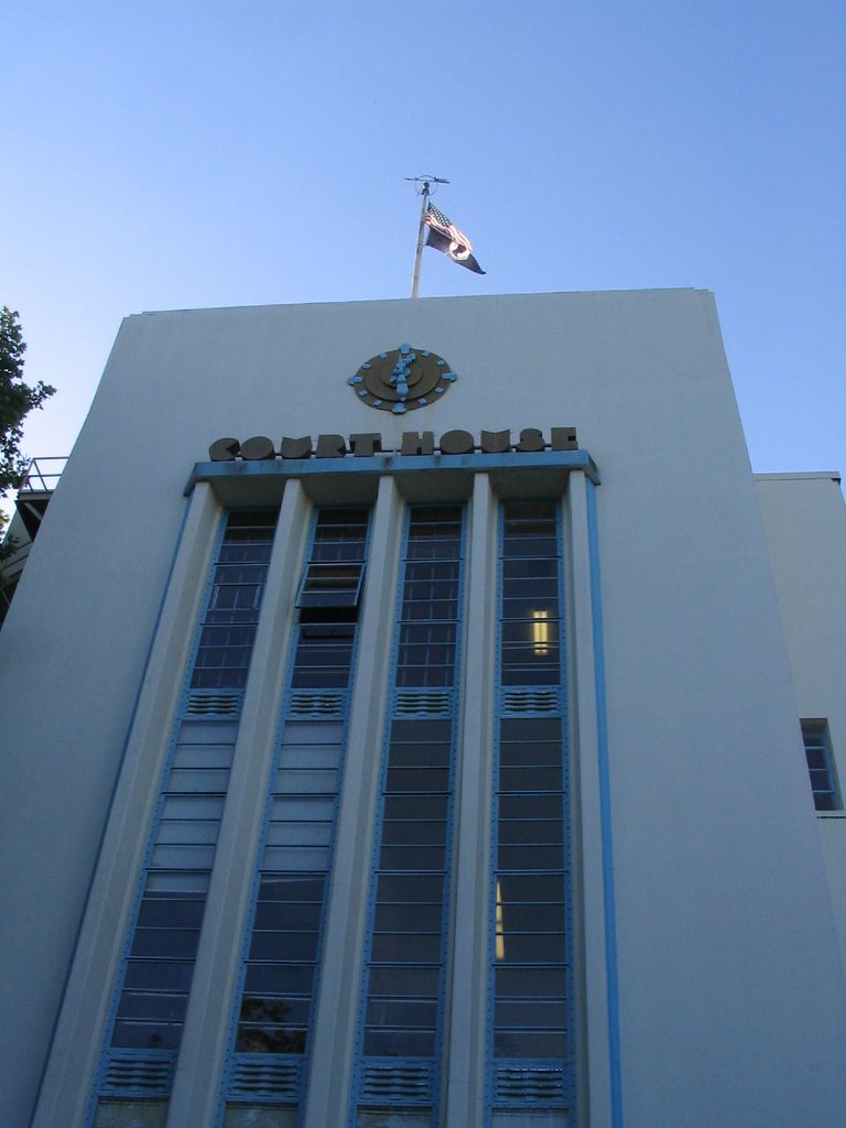 The Art Deco Nevada County Courthouse in Nevada City, California, with its flag flying against a blue sky