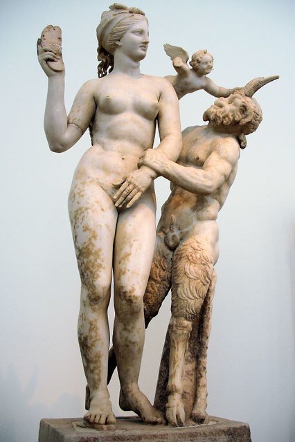 Aphrodite, Pan and Eros. The goddess is threatening Pan with her sandal, while Eros over her shoulder is grasping Pan's horn. Delos, c. 100 BC. National Archaeological Museum, Athens.