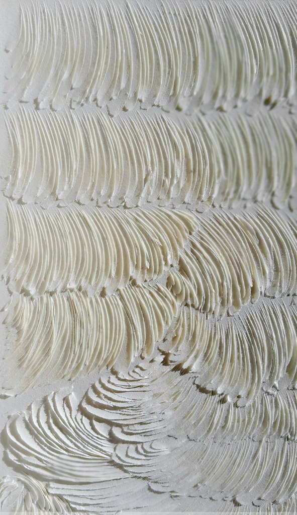 heavily carved white paper creates textured surface