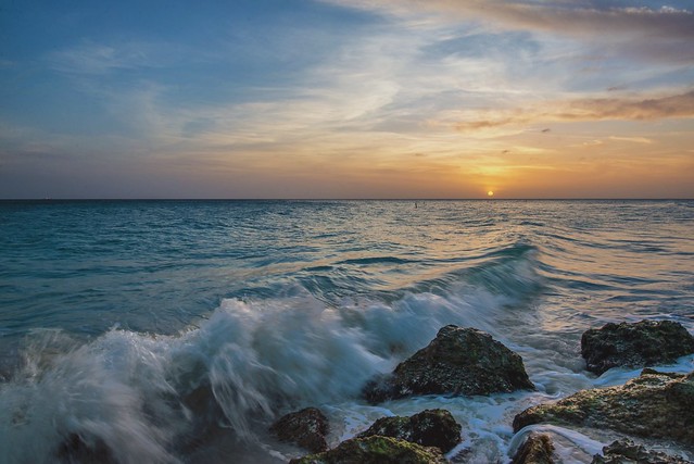 The sun sets as waves crash in at the Divi All Inclusive Resort in Aruba