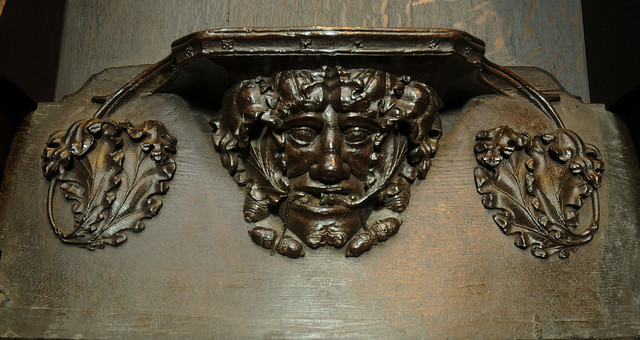 Lincoln Cathedral, Choir stalls, misericord N6, foliate mask among oak leaves and acorns; supporters, single leaves