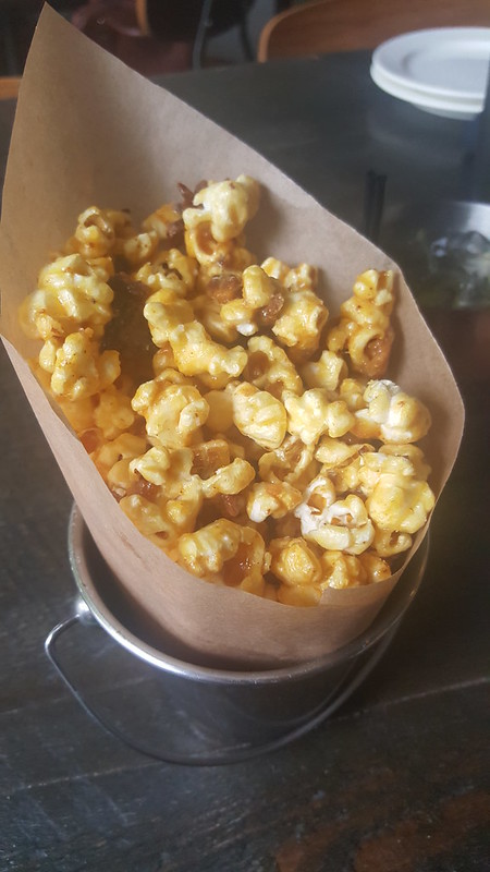 Bacon caramel popcorn in parchment paper on a table