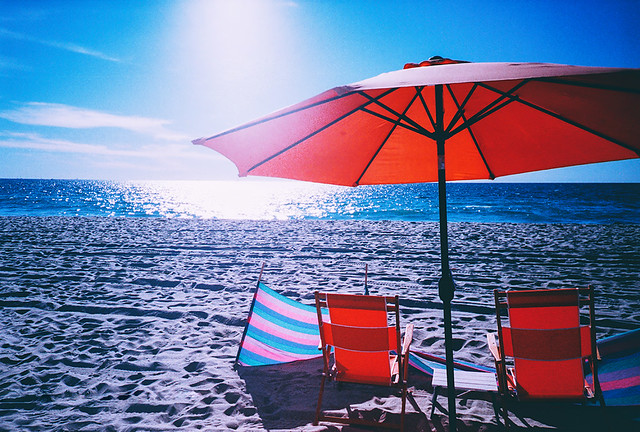 Red Chairs and Umbrella with Blue Sea and Sky