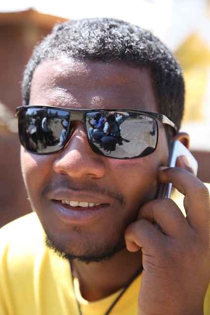 Male Portrait Cell Phone and Shades Lalibela Ethiopia Africa