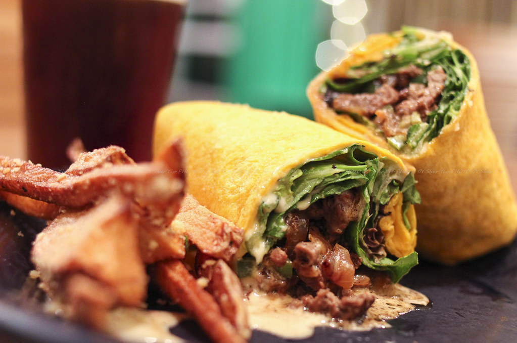 Steak-n-Cheese wrap - grilled sirloin , caramelized onions, grilled jalapenos, smother it  in-house queso, add lettuce and wrap it in a pepper cheese tortilla.  Comes with hand cut parmesan seasoned fries