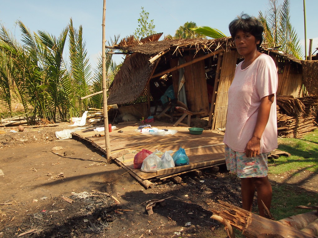 Women ifront of her destroyed house in BRGY Linateran.Pana… | Flickr