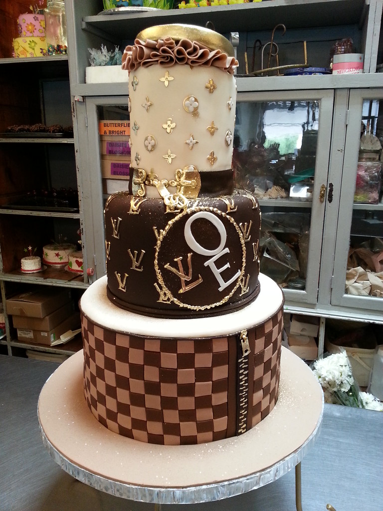 Louis Vuitton themed cake iced in butter icing with 3D han…