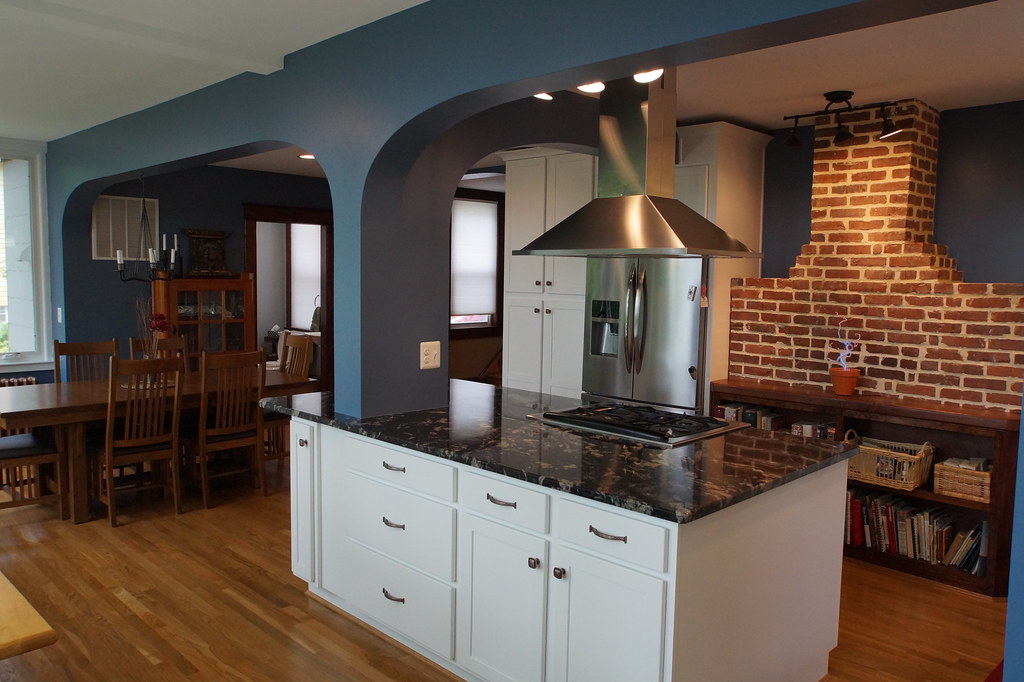 AFTER- Close-up of the kitchen island and the brick chimney. Note the custom bookcase in front of the brick chimney. We built this bookcase on site and use the old fireplace mantle as the bookcase countertop.