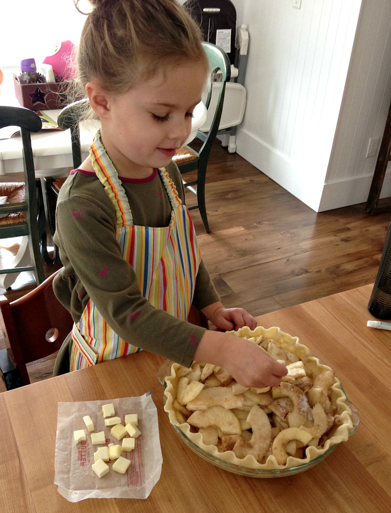 little girl helping to mix batter