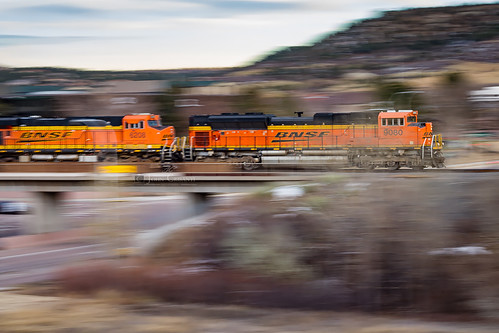 Zipping Through Colorado Springs by Colorado & Southern, A southbound Texas coal load crosses S. Rockrimmon Boulevard just after sunset on an overpass in Col