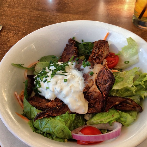 Hogs Breath Cafe Cajun Beef & Ranch Salad. BBQ rib strips blackened seasoning on lettuce, cucumbers, carrots and cherry tomato topped with cucumber yoghurt dip