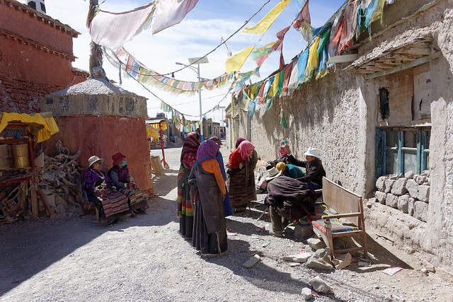 Curiously the elderly listen to his story, Tibet 2015
