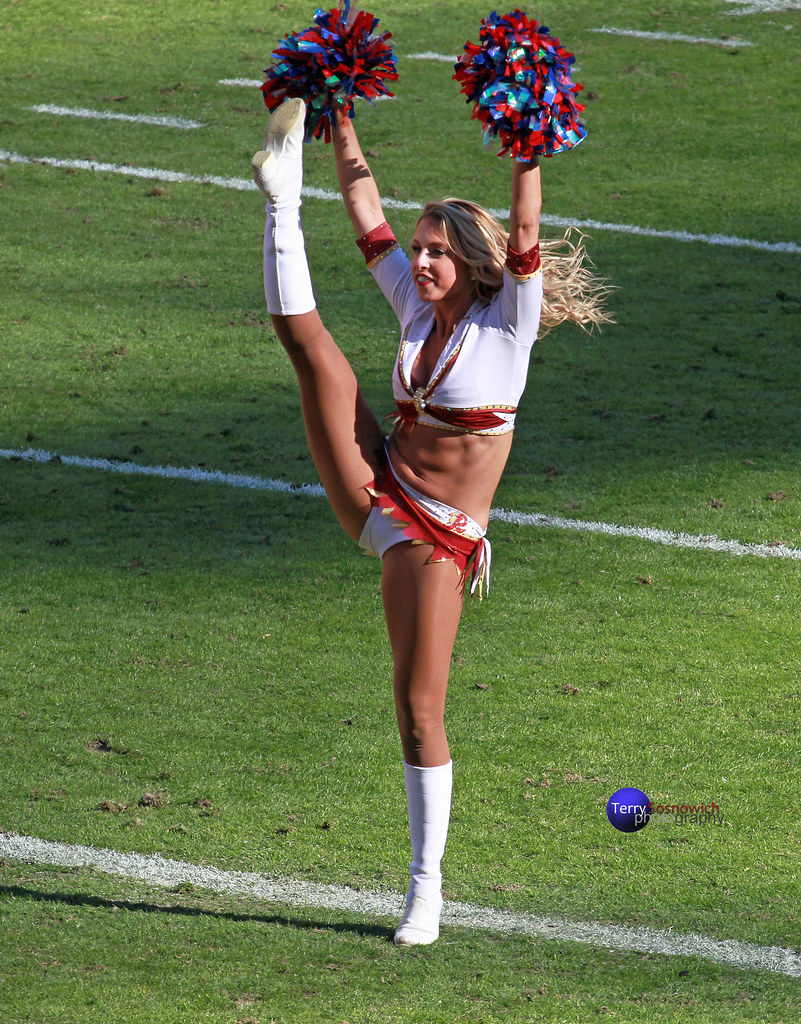 Redskinette Cheerleader Heather kicks up her leg. 