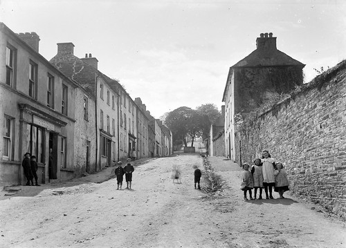 unknowntown steephill children pinafores shop trees roundabout street ghosts castletownshend cork ~1910 ireland ferguso’connor ferguso’connorcollection glassnegative nationallibraryofireland candid shot foto old vintage history kinder locationidentified