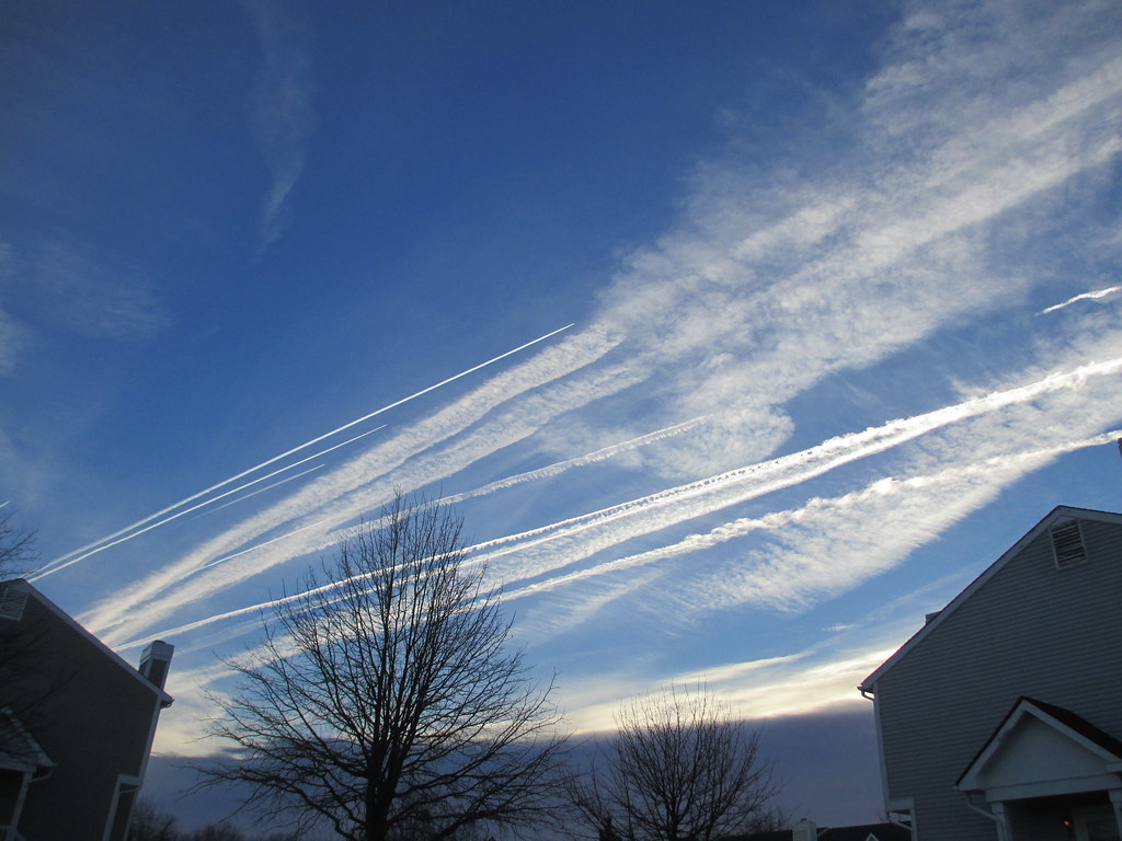 photo of aircraft contrails at sunset