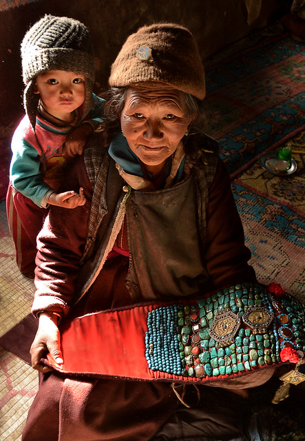 A grandmother with her nice grandson in their traditional mud ladakhi house, India
