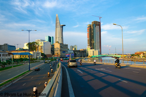 road street city travel bridge blue sunset red sky urban cloud color building tree green tower window skyline architecture modern skyscraper river way landscape hotel office high construction asia downtown day vietnamese cityscape view traffic outdoor dusk top district background landmark scene structure line vietnam business tall flowing saigon gloaming
