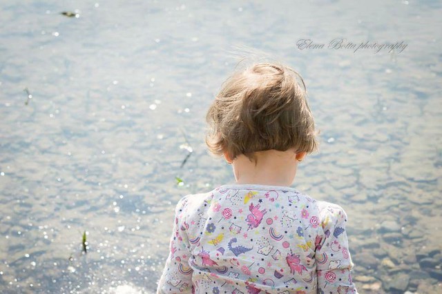 Little girl on riverbank
