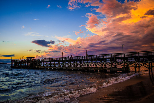 ocean sunset sky sun beach water clouds lights pier dock colours