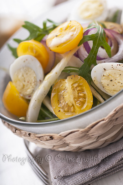 Fresh salad with yellow cherry tomatoes, fennel and quail eggs
