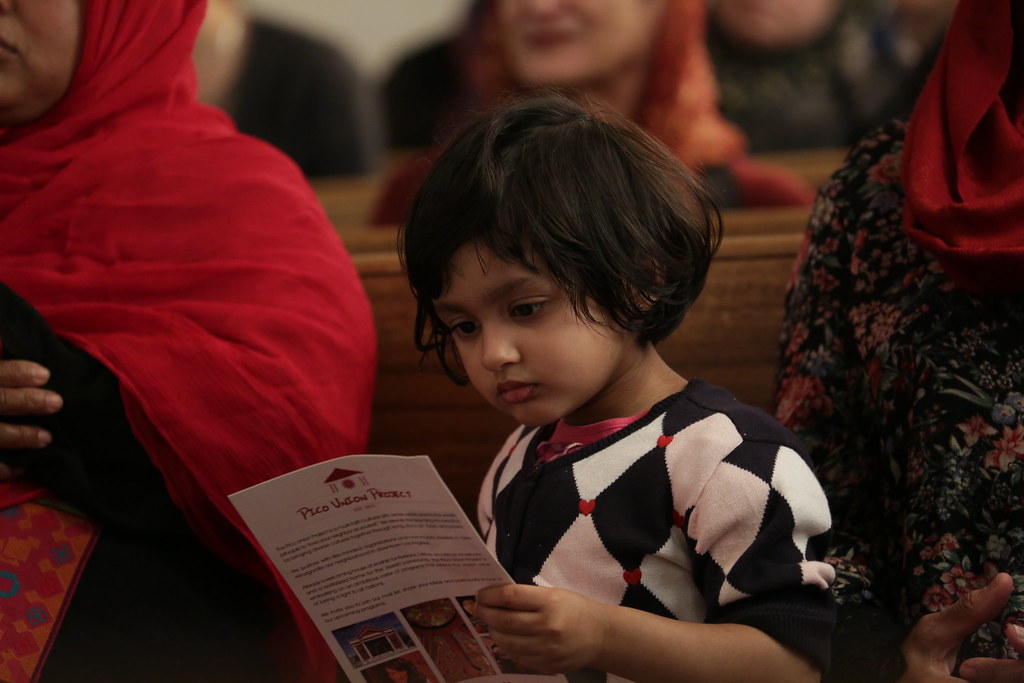 PILA2217 Congregant and her child listen to the announceme… | Flickr