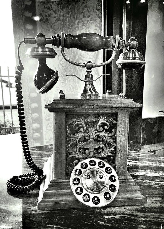 A black-and-white photo of an antique telephone