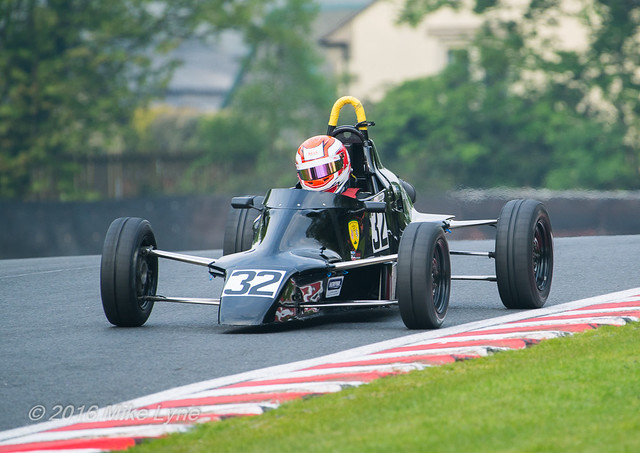 Formula Ford 1600  crests the rise on the exit from Druids
