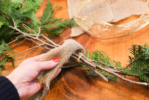 Wrapping burlap strips around fresh pine cuttings for a Ch… | Flickr