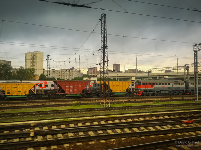 Train carriages with a moody sky behind